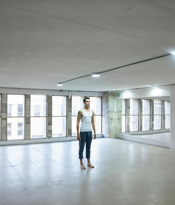 Person practicing a mindful exercise in a bright, minimalist room.